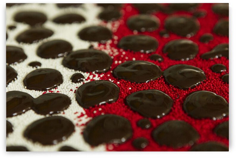 Chocolate Drops on Deep Red and White Nonpareils. by Iris H Richardson
