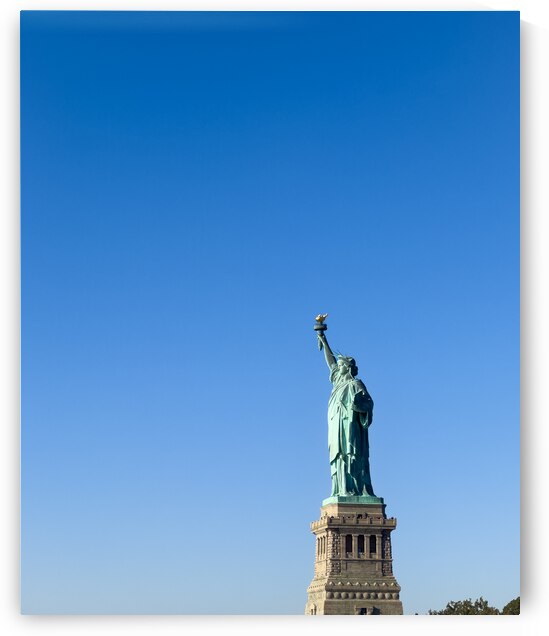 Statue of Liberty with bright blue sky by Jacobo Gutierrez