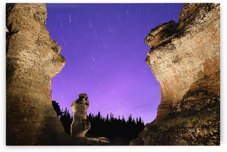 Light painting on monolith and star trails, Anse des Bonnes Femmes at Ile Niapiskau, Mingan Archipelago National Park Reserve of Canada, Cote-Nord, Duplessis region; Quebec, Canada by PacificStock