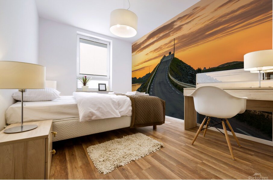 A car on the Fredvang bridges in Lofoten Norway with a beautiful sunset over the sea.  Mural print