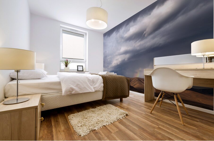 Rainbow with diagonal clouds over morning light on mountains Mural print