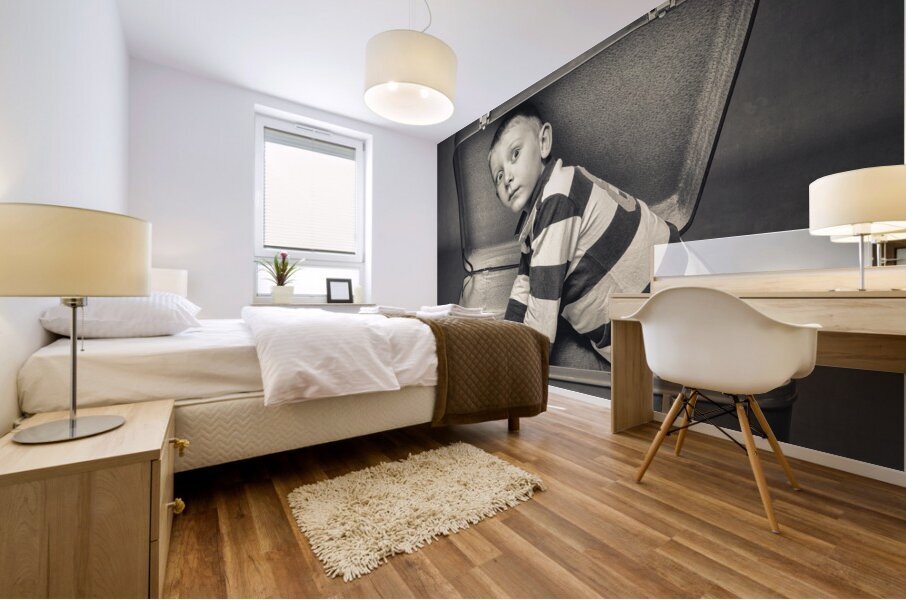 child with astonished expression in a suitcase Mural print