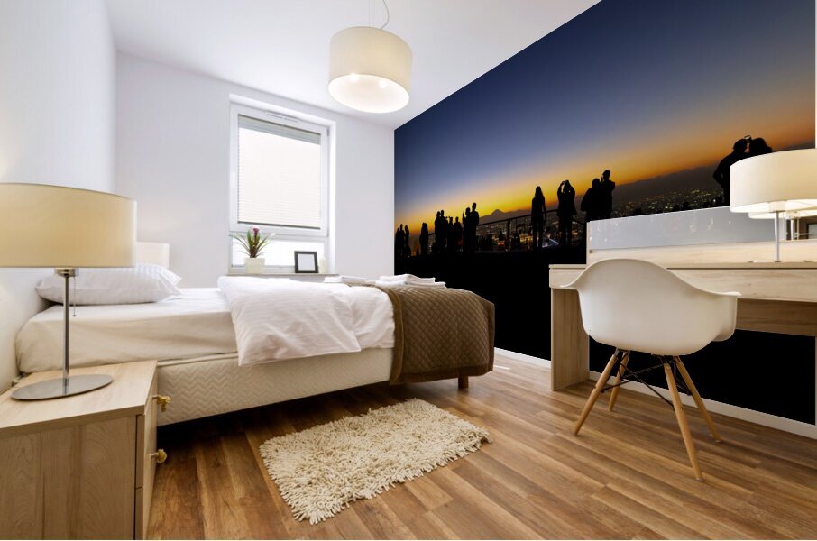 Silhouetted figures observing sunset cityscape Mural print