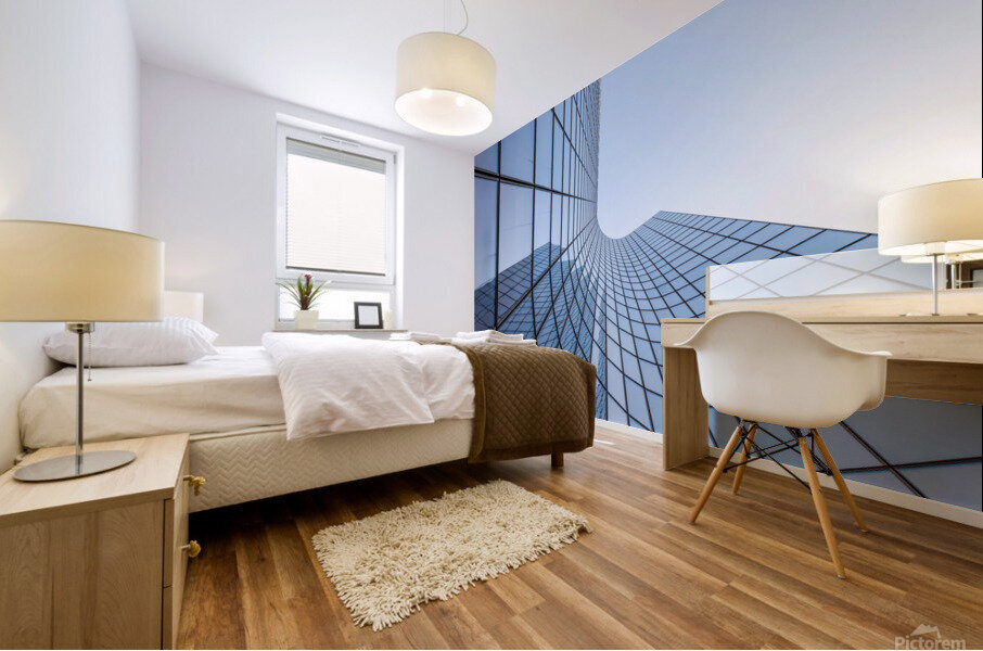 Blue curved glass skyscraper facade against sky Mural print