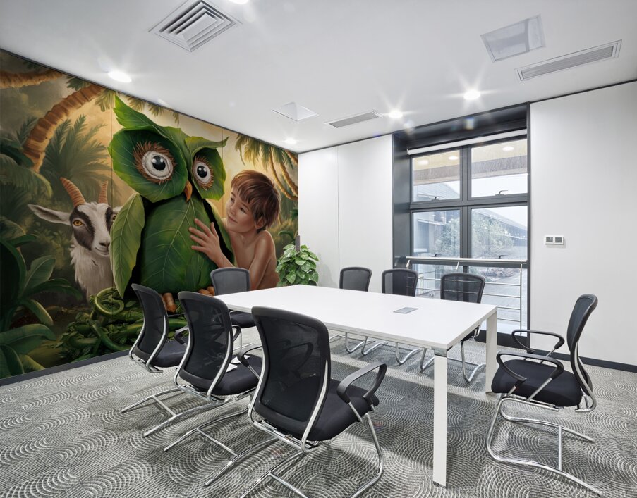 young boy gently touches a large owl-shaped structure made of green leaves Wall Printing