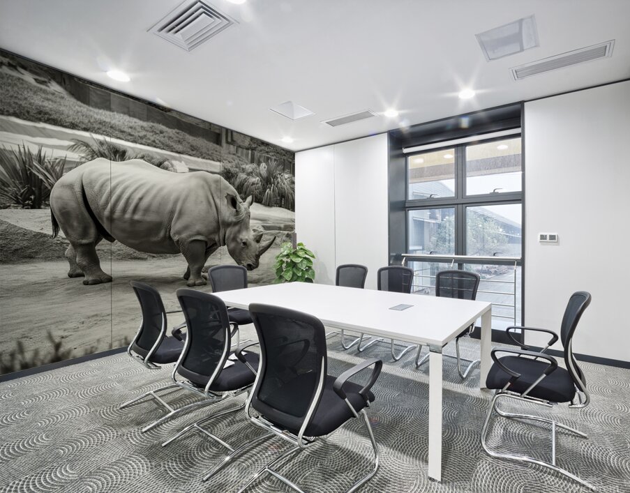 A rhinoceros in what appears to be a zoo or wildl Wall Printing