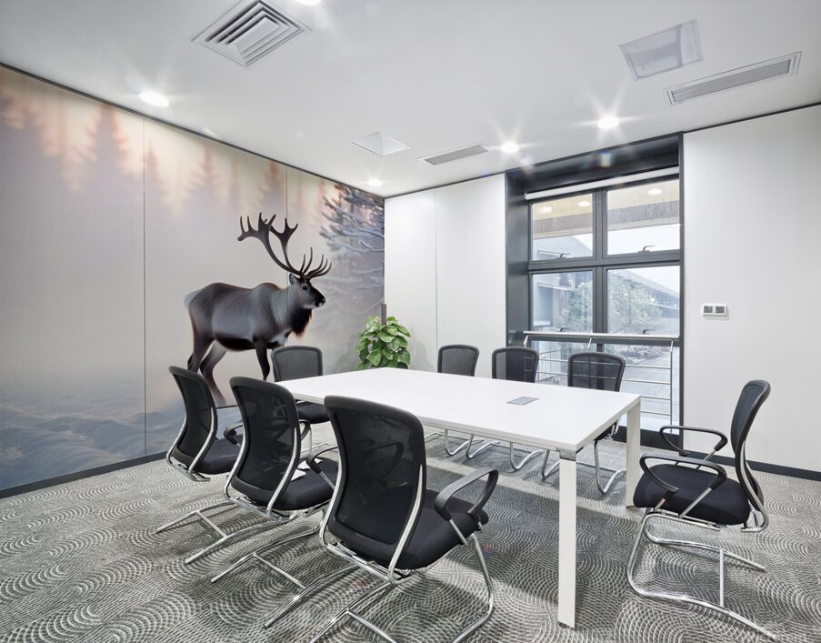 A reindeer searches for grass sprouts in the snow Wall Printing
