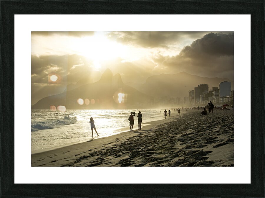 People enjoying dramatic sunset at Ipanema Beach in Rio de Janeiro  Picture Frame print