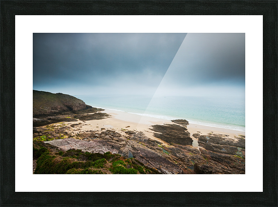 Beach with rocks and cloudy dark sky Picture Frame print