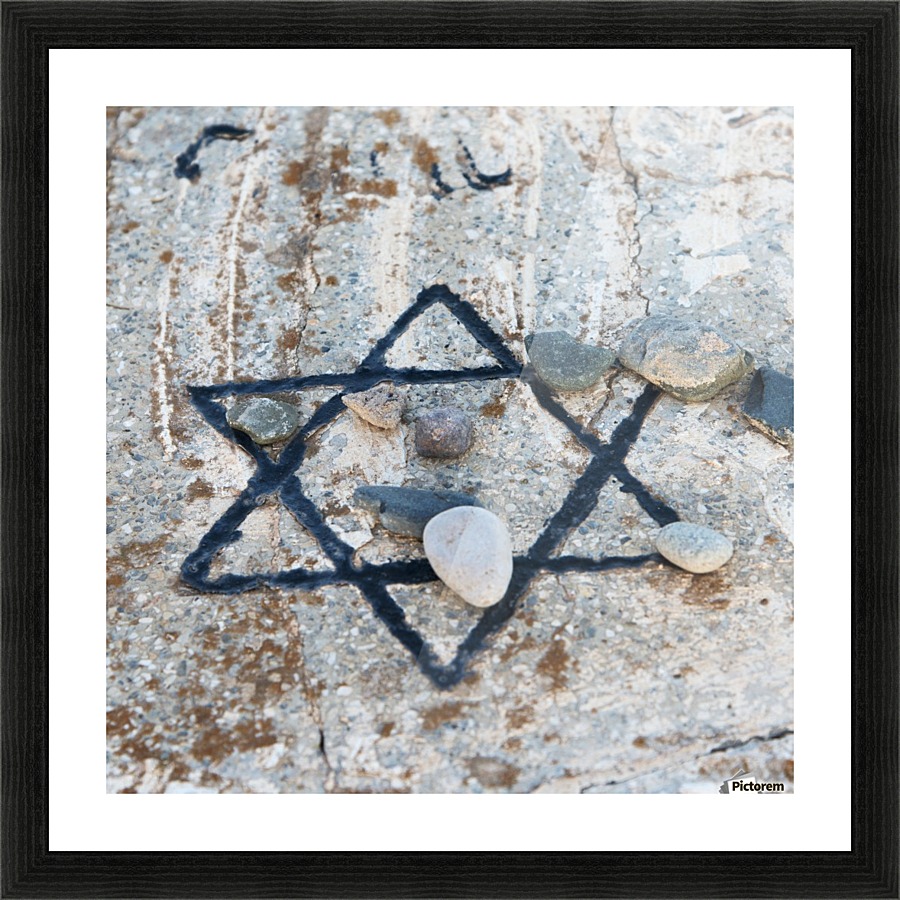 A star of david etched and painted on a rock with stones laying on it Picture Frame print