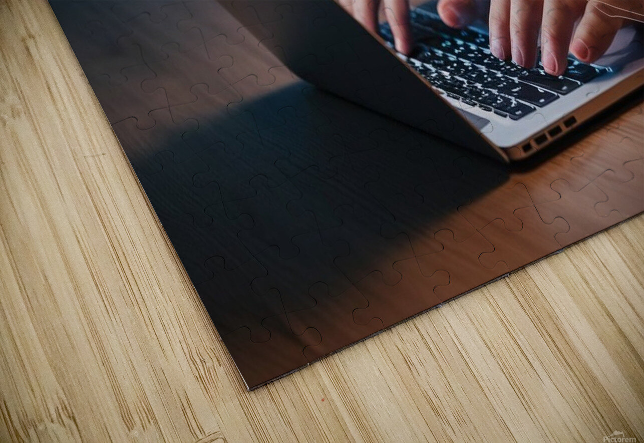 a person using a laptop at a table a stock photo Sam Digital Puzzle