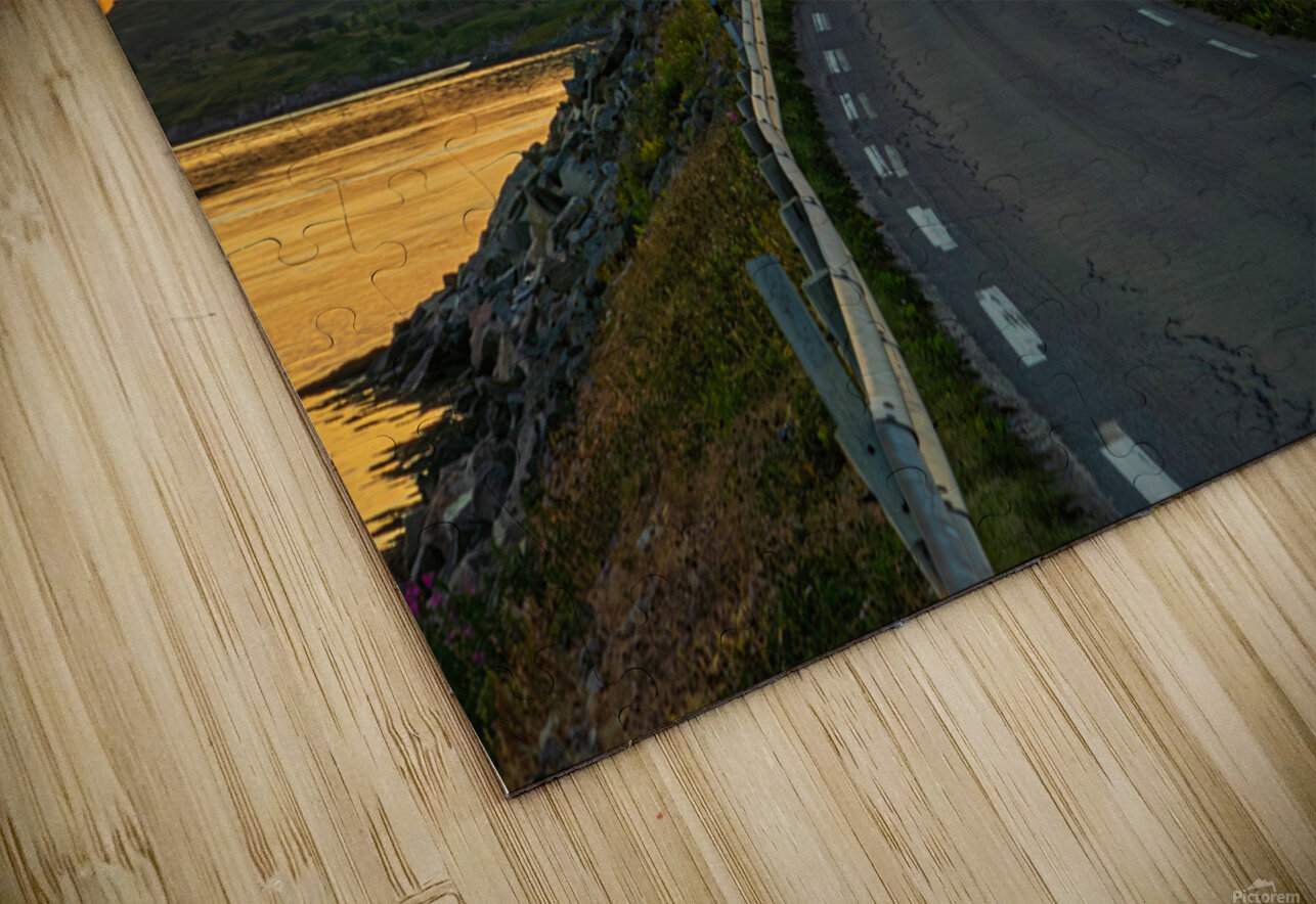 A car on the Fredvang bridges in Lofoten Norway with a beautiful sunset over the sea.  John Nilsson Puzzle