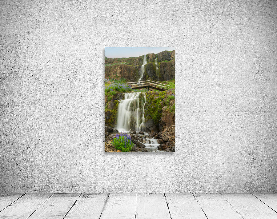 Budareyrarfoss waterfall cascades down the mountain by the port  Wall Preview