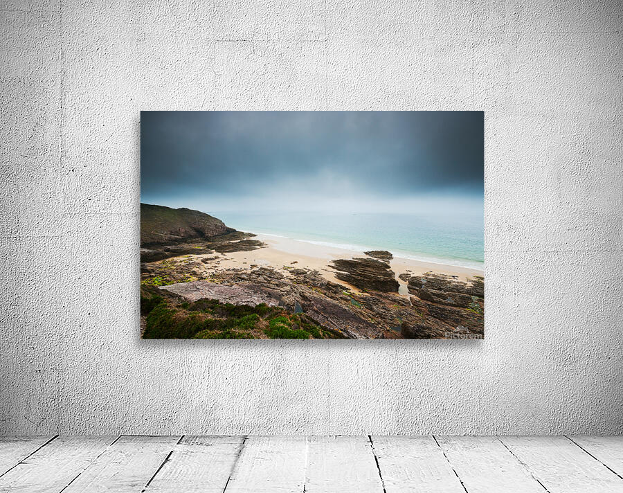 Beach with rocks and cloudy dark sky Wall Preview