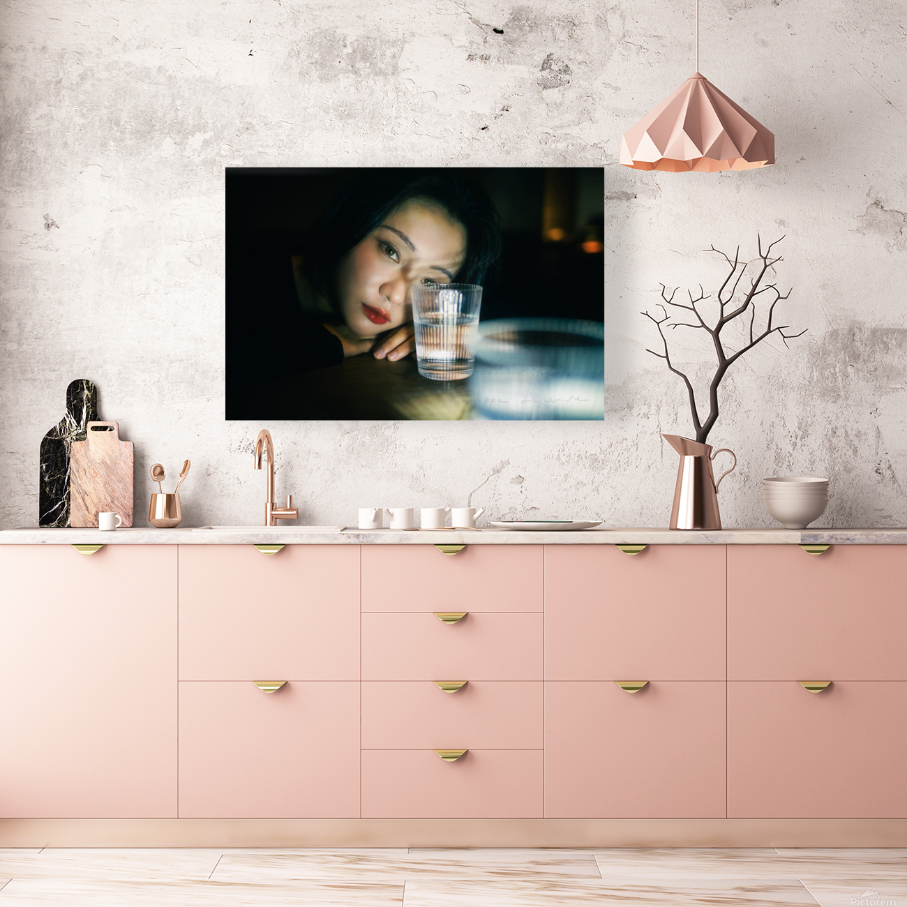 Young woman looking through a glass of water Reproduction