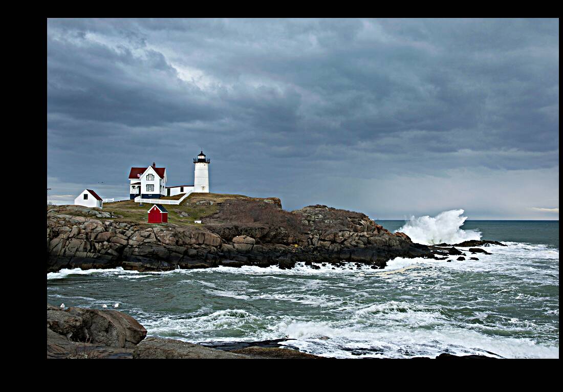 Sunlight Breaking Through Storm Clouds Over Nubble Light in Maine Reproduction