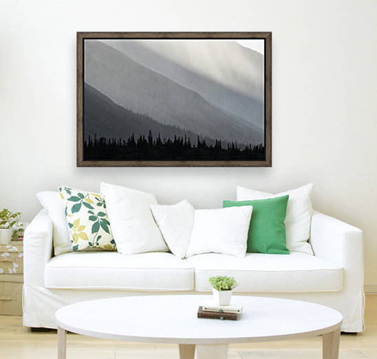 Light shines through the rain as it falls on the mountains along the Wind River in the Peel Watershed; Yukon, Canada by PacificStock