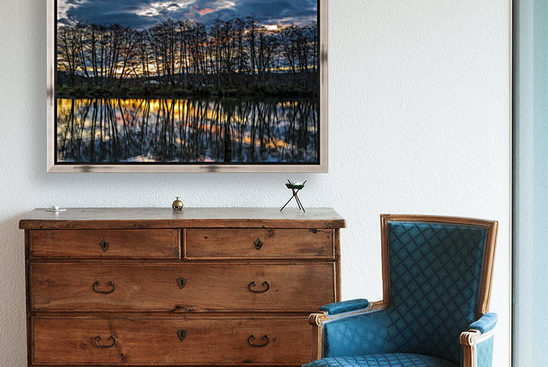 The sun rises along the Lewis and Clark River; Astoria, Oregon, United States of America by PacificStock