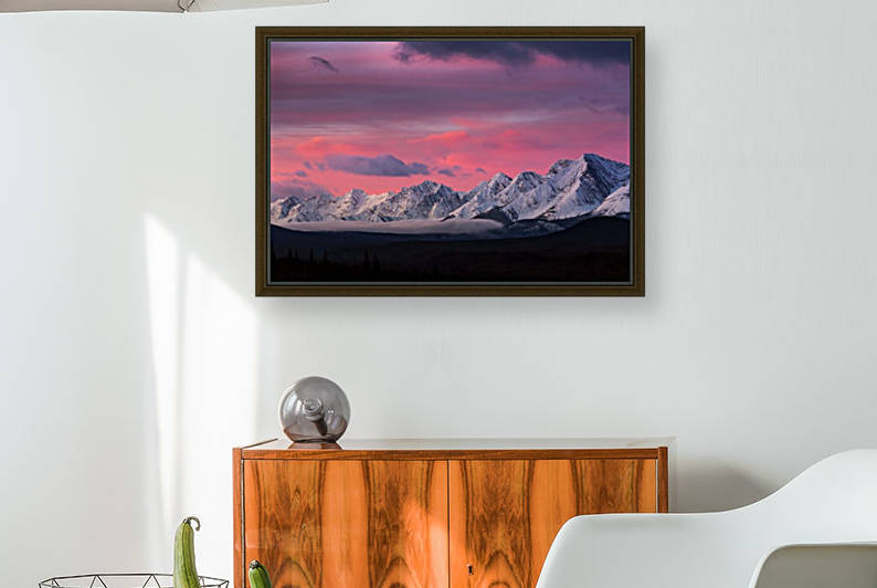 Dramatically glowing sky at sunrise with snow covered mountain range and fog in the valley; Kananaskis Country, Alberta, Canada by PacificStock