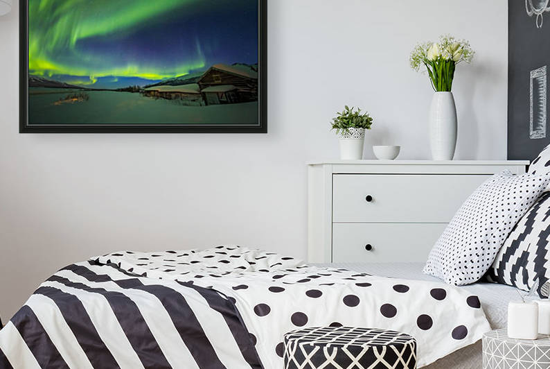 The aurora fills the sky above the historic Black Rapids Roadhouse along the Richardson Highway on a bitterly cold night; Alaska, United States of America by PacificStock