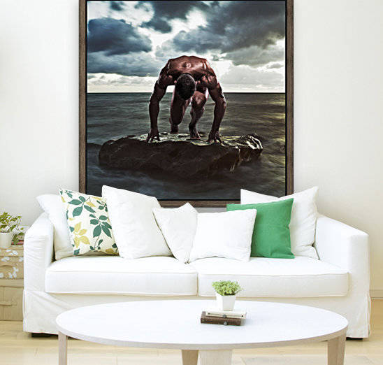 A muscular man in the starting position on a wet rock in the water;Tarifa cadiz andalusia spain by PacificStock
