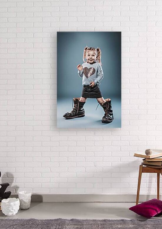 blonde girl plays with big boots. by Gualtiero Boffi