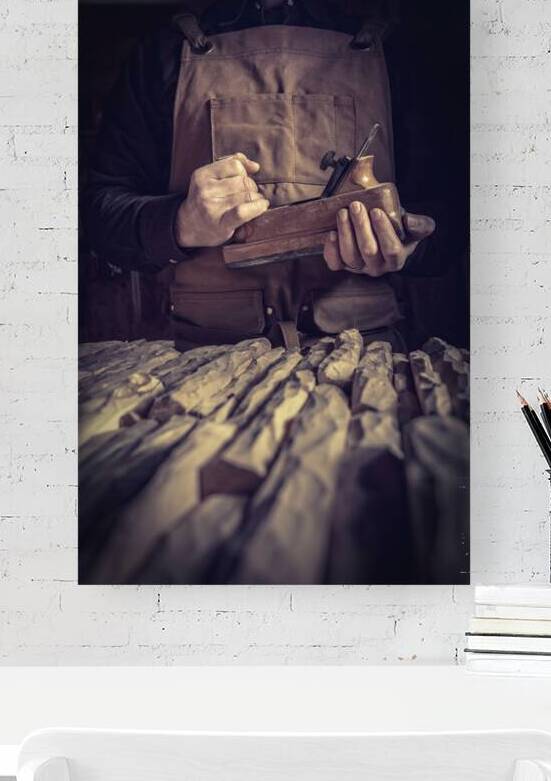 carpenter holding a planer by Gualtiero Boffi