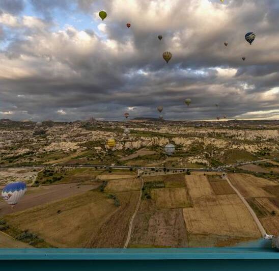 colorful hot air balloons fly at sunrise near goreme by Gualtiero Boffi