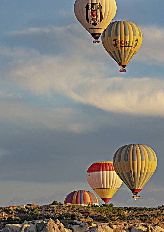 hot air balloons fly over goreme  by Gualtiero Boffi