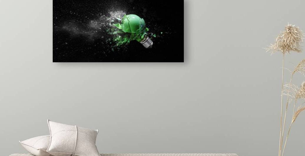 green electric light bulb exploding by Gualtiero Boffi