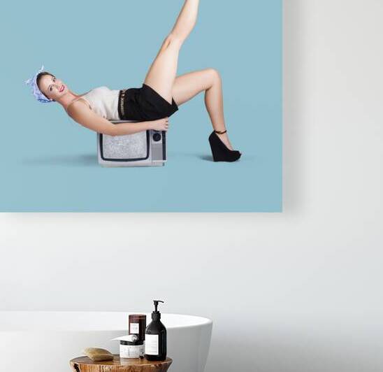 Pinup girl balancing on television set by Jorgo