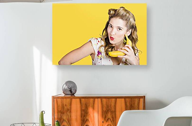 Pinup woman ordering organic fruit on banana phone by Jorgo