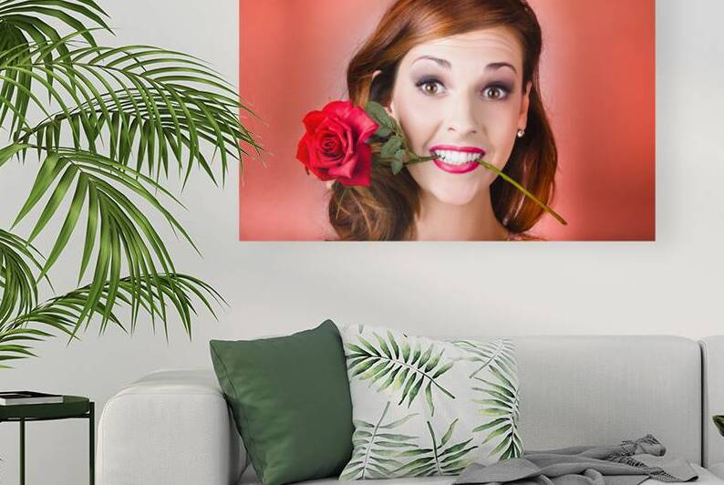 Woman gripping red rose between her teeth by Jorgo