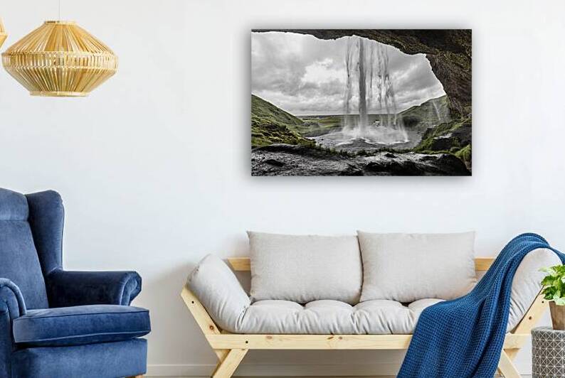 Seljalandsfoss waterfall crashing down on a cloudy day in icelan by Gualtiero Boffi