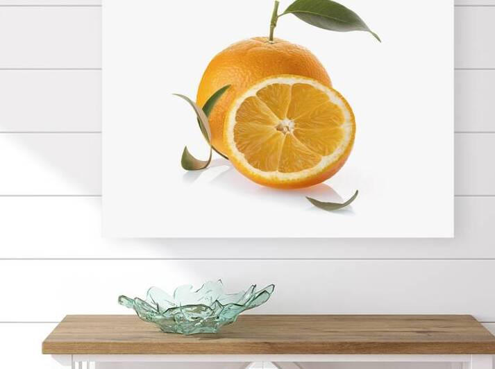 sliced orange fruit with leaves isolated on white by Romeu Hurmuzache