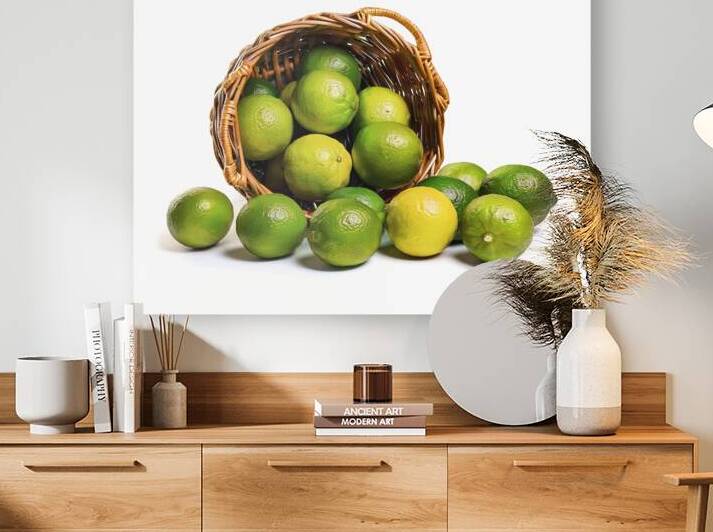 A wicker basket filled with green limes 2 by Romeu Hurmuzache