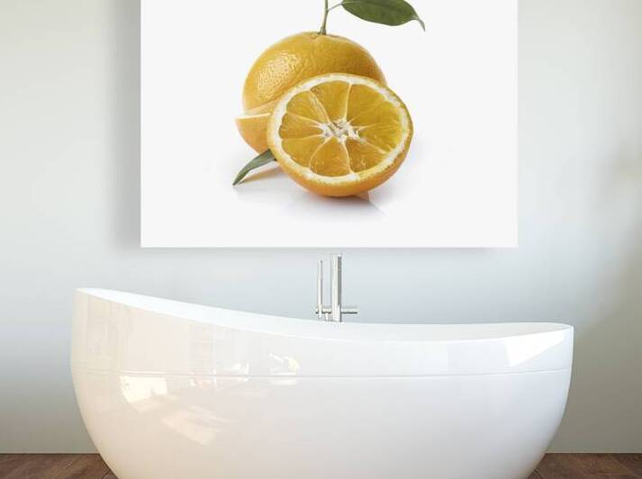 sliced orange fruit with leaves isolated on white by Romeu Hurmuzache