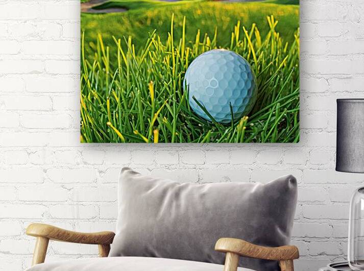 Golf ball close up on green grass on blurred beau by Mirela Poiana