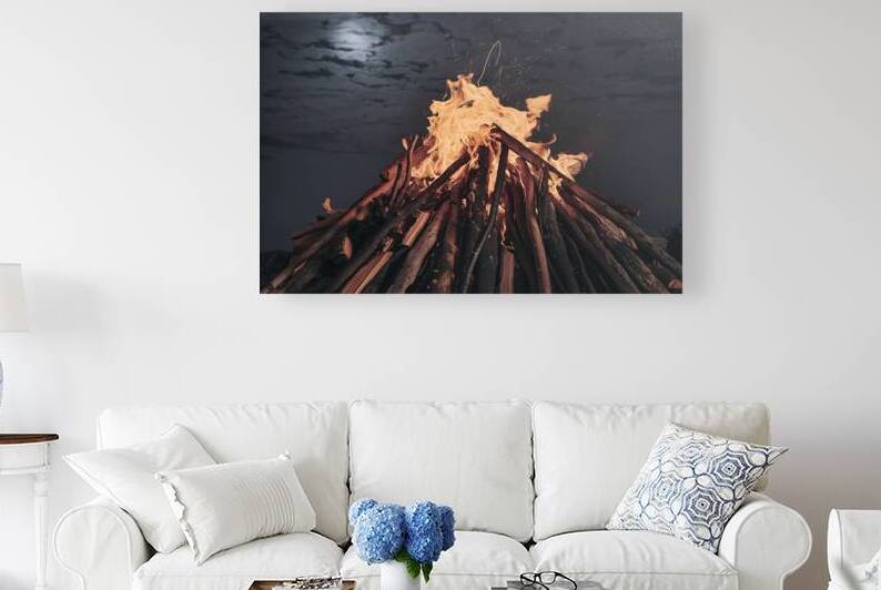 A mesmerizing nighttime scene of a large fiery bo by Mitica Mihaila