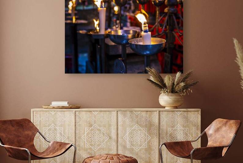 Many candles burning in a temple at night by Gualtiero Boffi