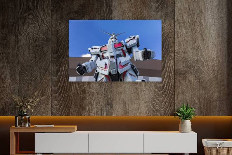 Giant gundam robot standing tall against blue sky in odaiba by Gualtiero Boffi