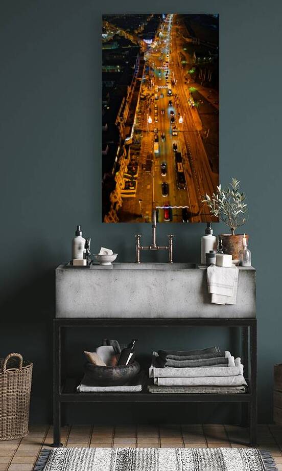 Aerial night view of a bustling city street with glowing traffic lights and cars in motion in Backpool England. by Vasile Jechiu