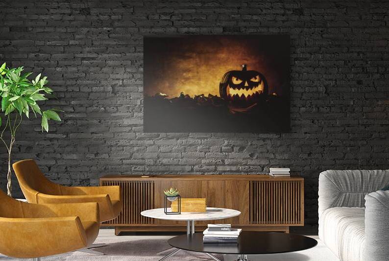 Halloween pumpkin glowing on autumn leaves background by Gualtiero Boffi