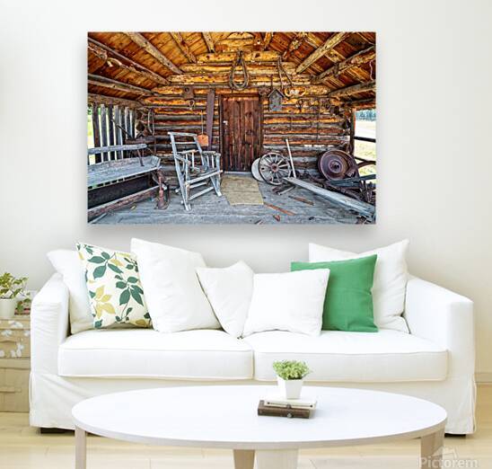 The porch and front entrance to a rustic log cabin by David Reinhold