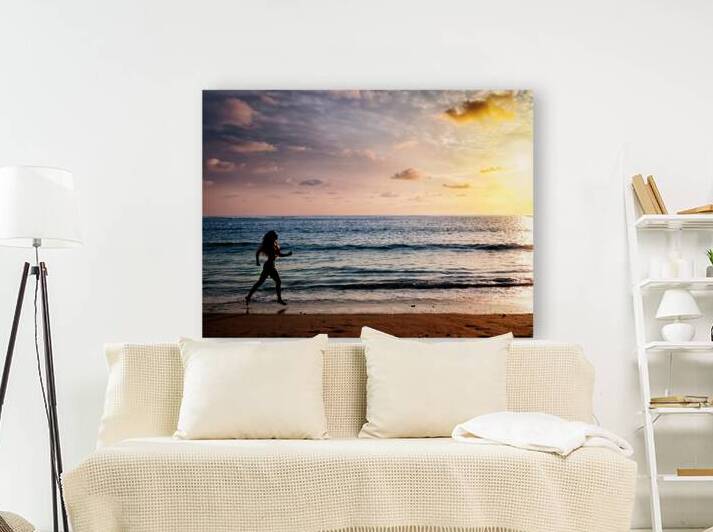 Beautiful athletic woman running along sea beach in the morning by Dmitry Rukhlenko