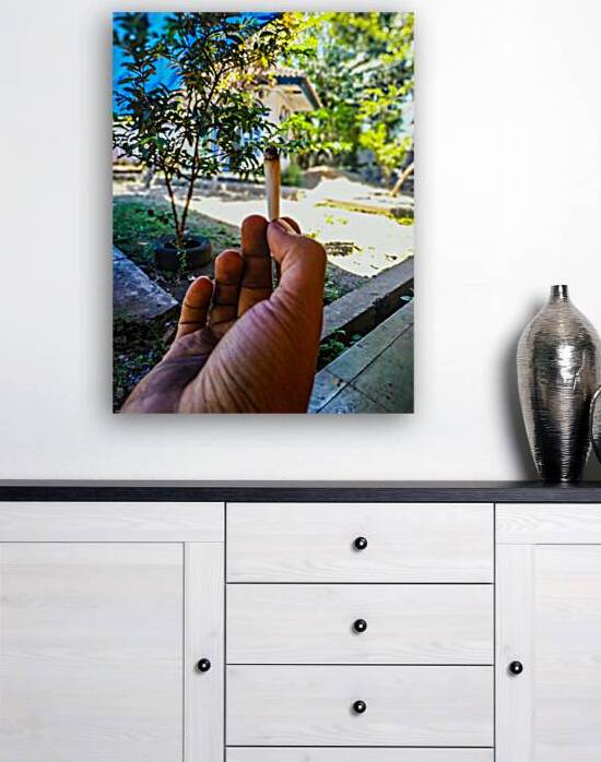 Hand Holding a Traditional Cigarette in a Serene by urbancamshot