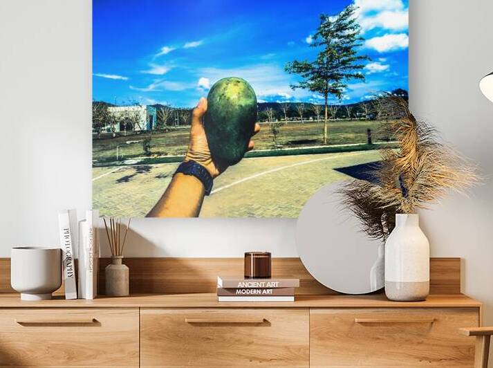 Holding a Large Green Mango Outdoors by urbancamshot