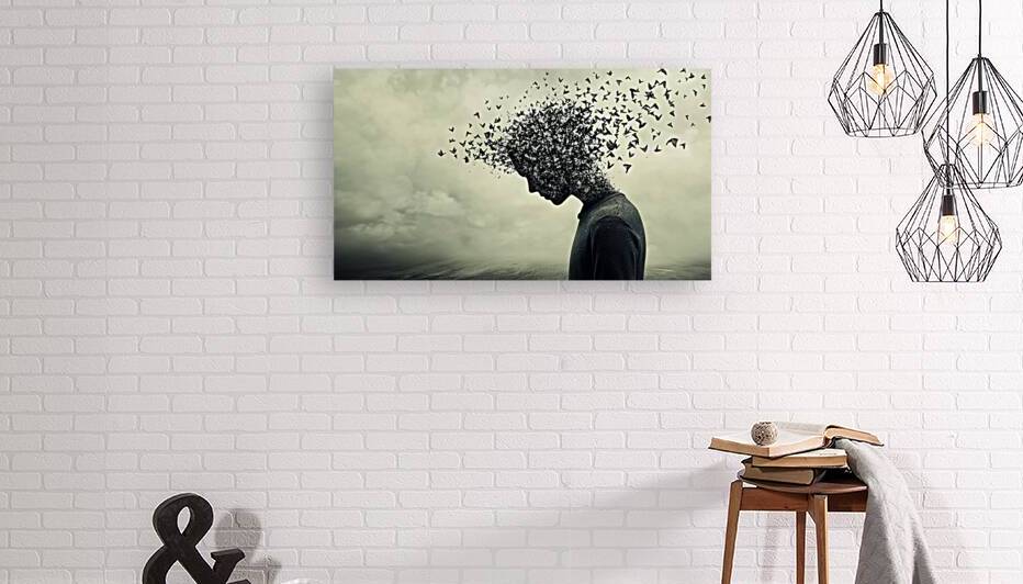 Human silhouette dissolving into a swarm of birds against a cloudy sky backdrop by Ali Jaber