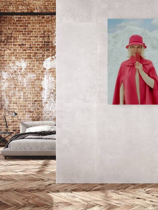 Vintage portrait of a blonde woman from the 1960s wearing a pink cape coat and cloche hat holding a popsicle in front of a mountain of snow in winter by Artmood Visualz