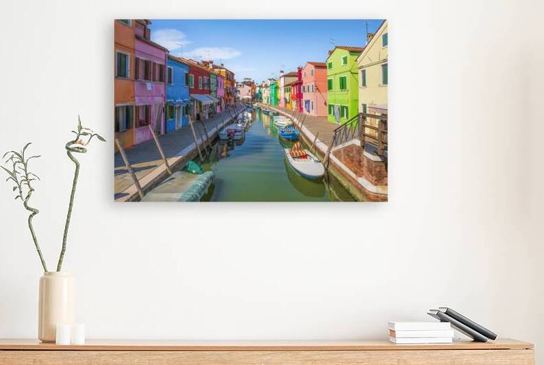 Burano island canal with colorful houses and boats by Stefano Orazzini
